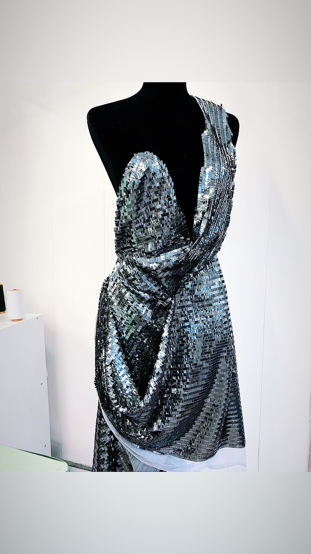 Floor-length silver sequin gown with deep V-back